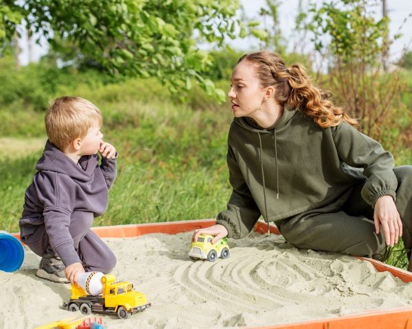 mother-and-kid-playing-with-toy-trucks-in-sandbox-2025-03-16-03-20-21-utc mother-and-kid-playing-with-toy-trucks-in-sandbox-2025-03-16-03-20-21-utc